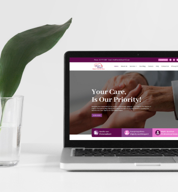 Image of a laptop with Heart to Heart's website on itand a cup next to it.